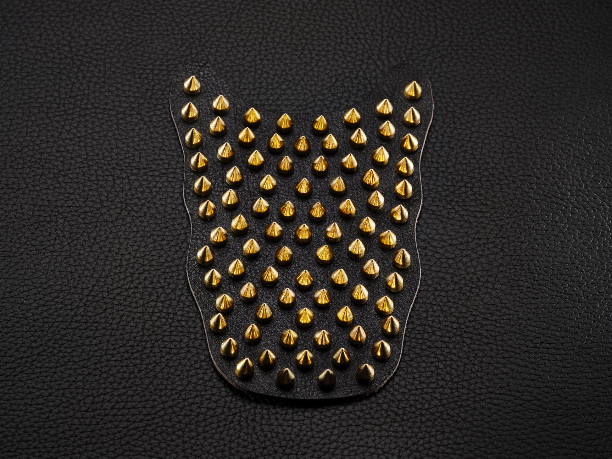 Black sneaker overlay with gold spikes for custom shoe styling.