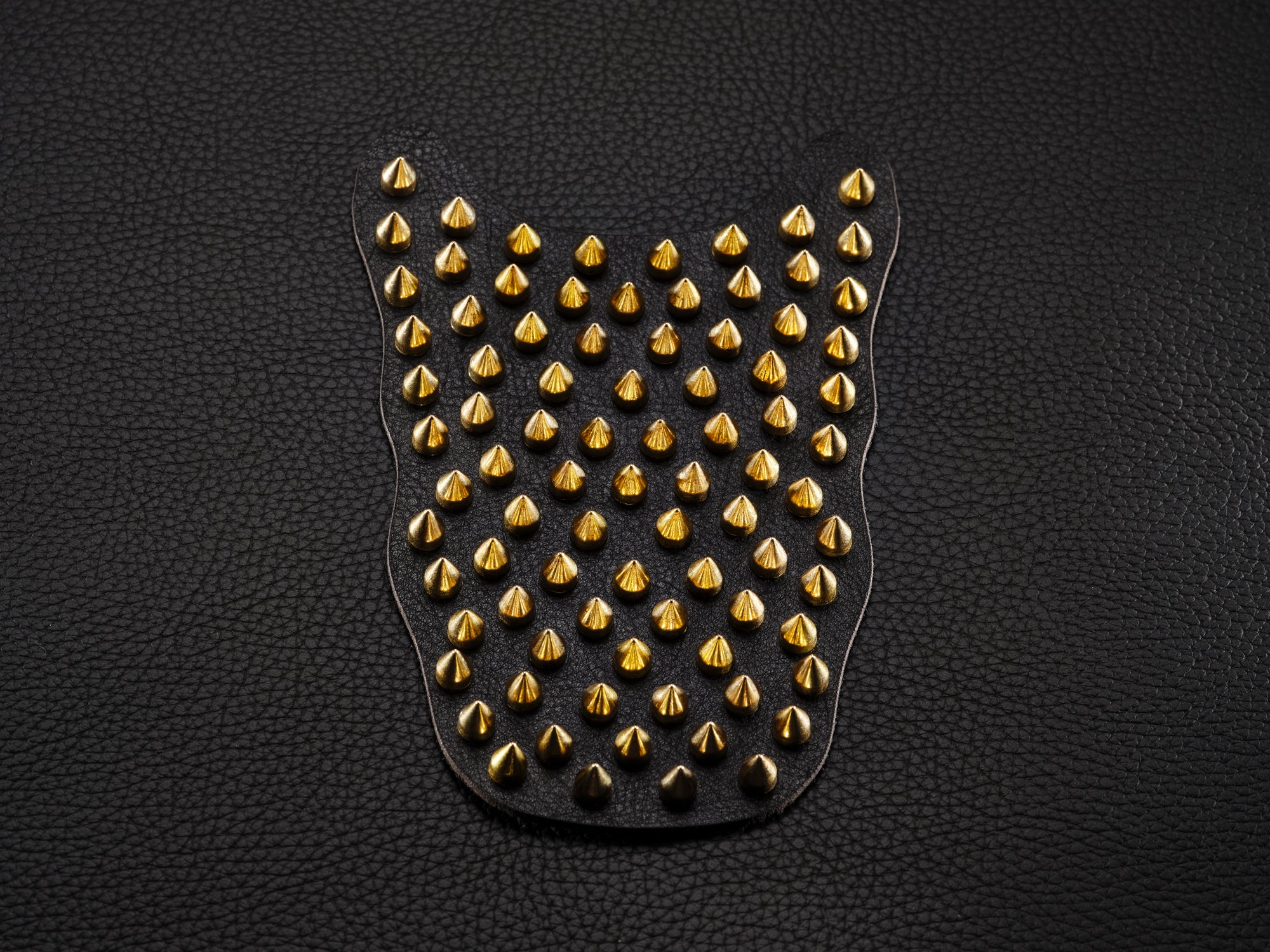 Black sneaker overlay with gold spikes for custom shoe styling.