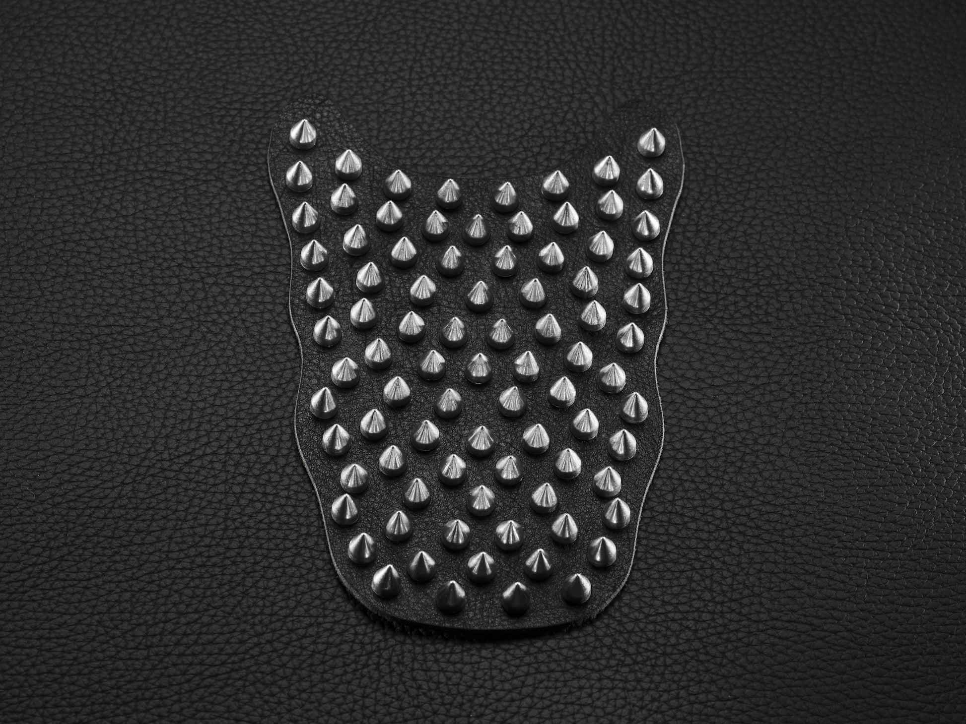 Black sneaker overlay with silver spikes for custom shoe styling.