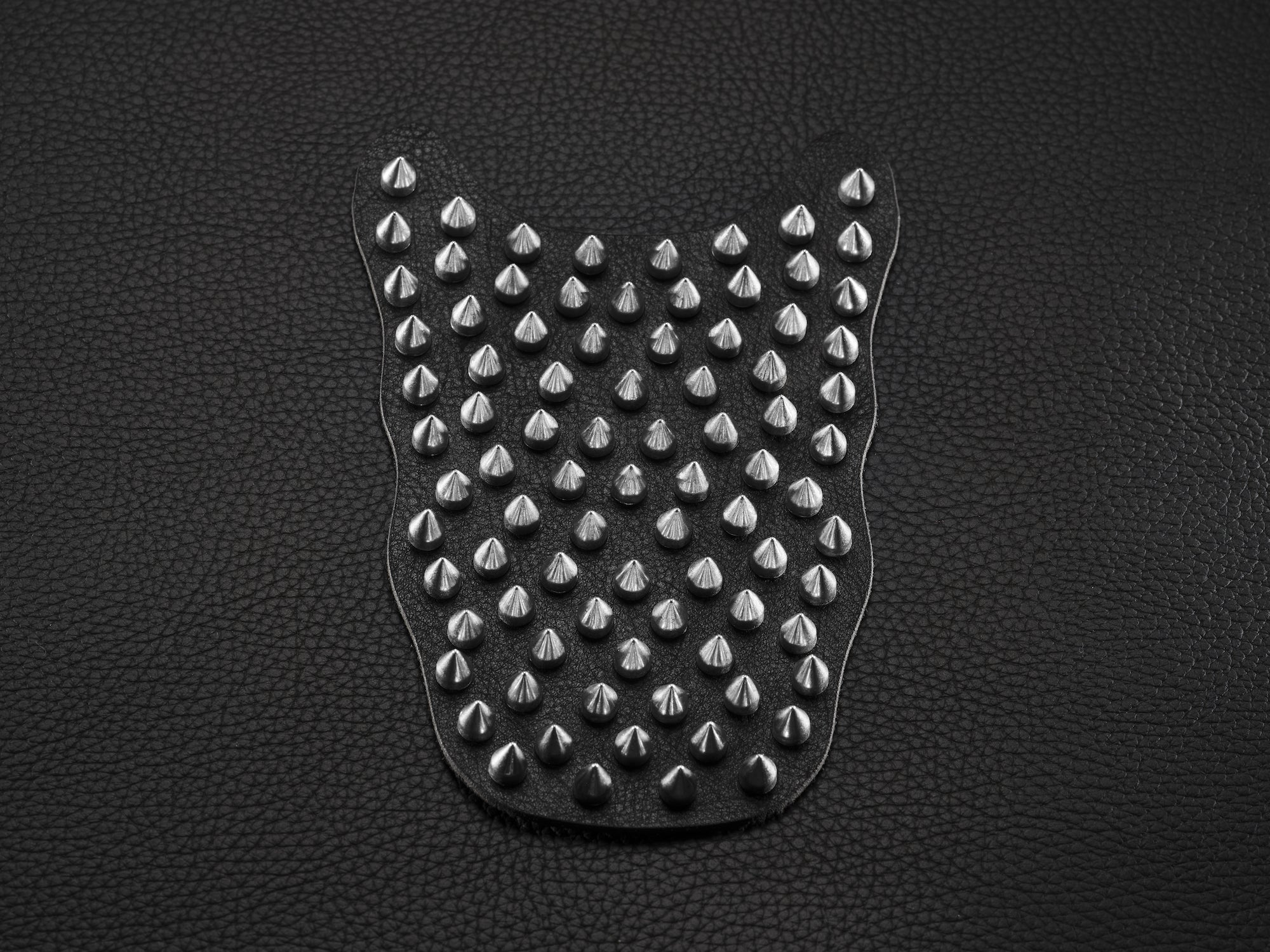 Black sneaker overlay with silver spikes for custom shoe styling.